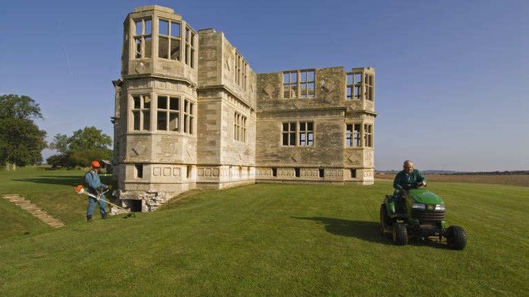 Strimming and mowing the grass at Lyveden New Bield, Peterborough, Northamptonshire. Staff and volunteers maintain the extensive grounds.